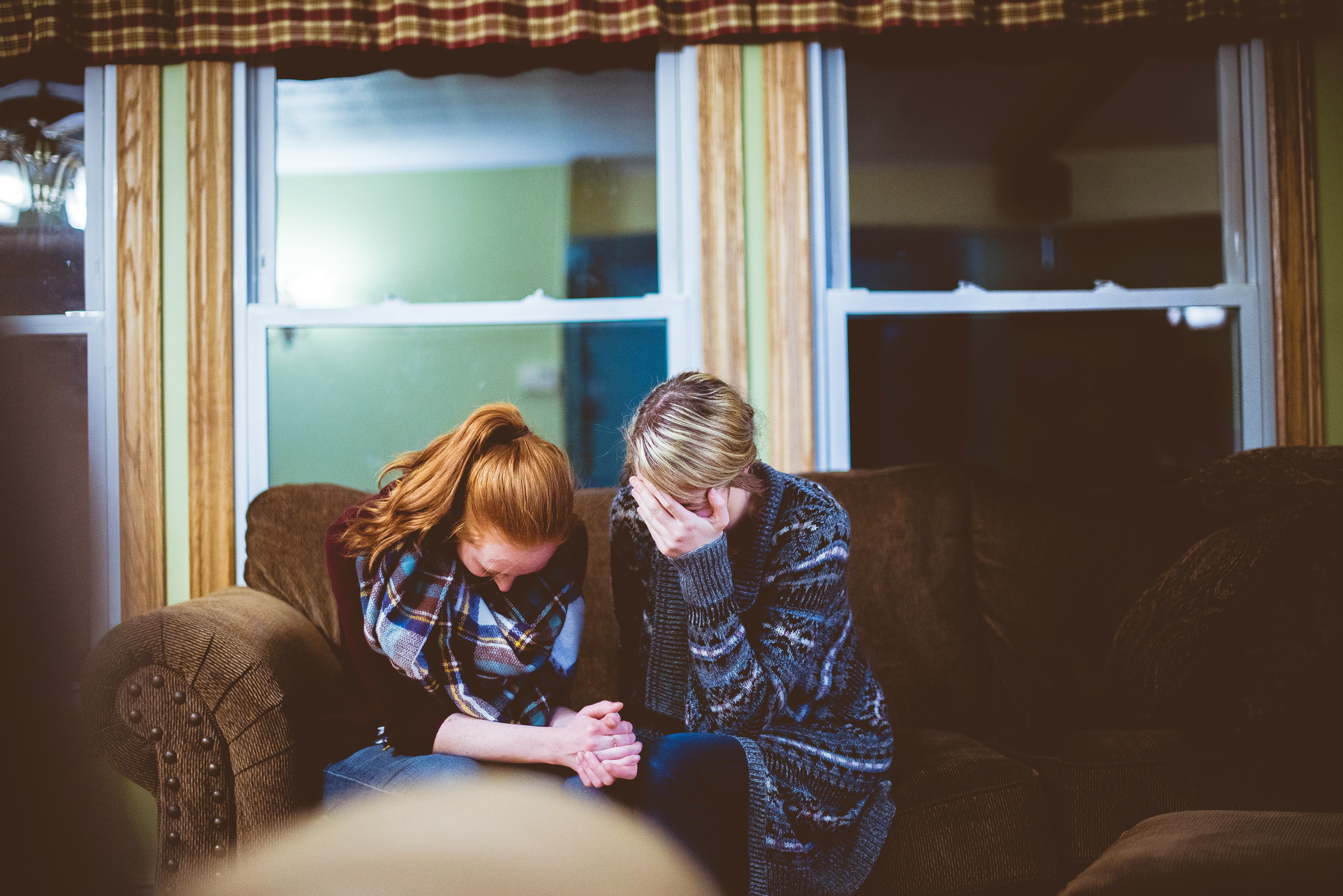 Two women grieving together in support
