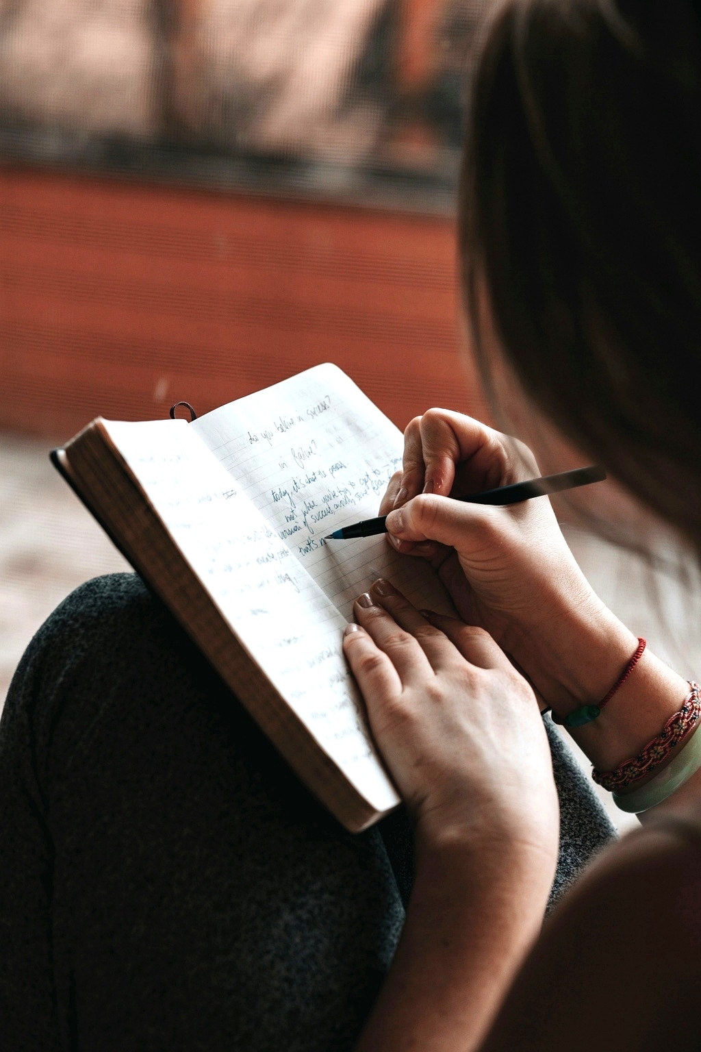 Woman writing in her journal with intention